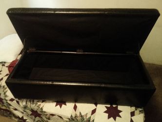 Faux leather rectangular storage ottoman bench featuring a smooth hinged lift top lid positioned at the foot of the bed