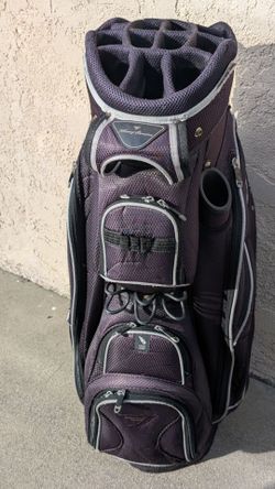 The TOMMY ARMOUlR MEN'S  CART GOLF BAG With 14 WAY TOP
A WELL FOR PUTTER  9 ZIPPERS POCKETS A RAIN COVER STYLES  UP BLACK/ SILVER STRIPES 
AN EASY HAN
