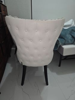 White leather tufted chairs