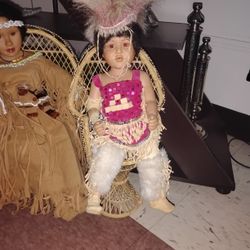 Vintage Porcelain Dolls In Wicker Chairs