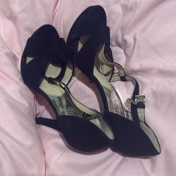 Michael Kors (MK) black suede heels with an ankle strap and block heel.