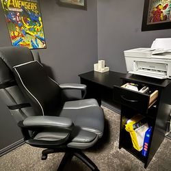 Office chair and desk with a printer stand.