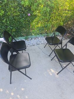 4 black steel folding chairs