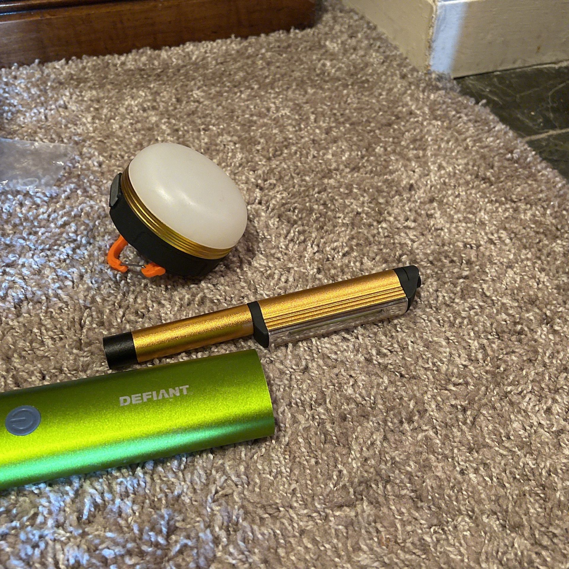 Magnetic flashlight, the green defiant brand with three settings of lights, and two chargers, and the round Hanging/magnetic Light