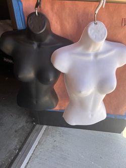 Hanging plastic mannequins.