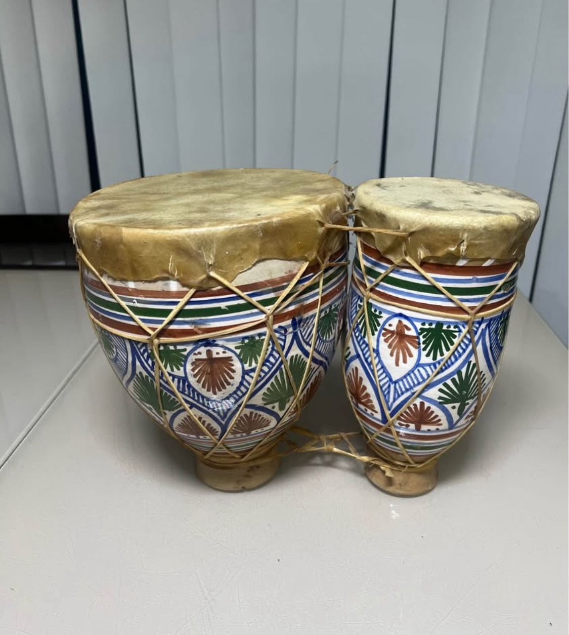 NORTH AFRICAN CERAMIC FOLK HAND PAINTED GREEN ,BROWN, BLUE PATTERN POTTERY AND ANIMAL HIDE BONGO DRUMS. Used in good condition with normal signs of us
