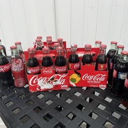 24  7oz Coke Bottles Various Years 35.00