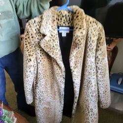 Woman's new leopard coat.\nSize large three hundred dollars , black and silver fur coat size , large three hundred dollars , both perfect , new