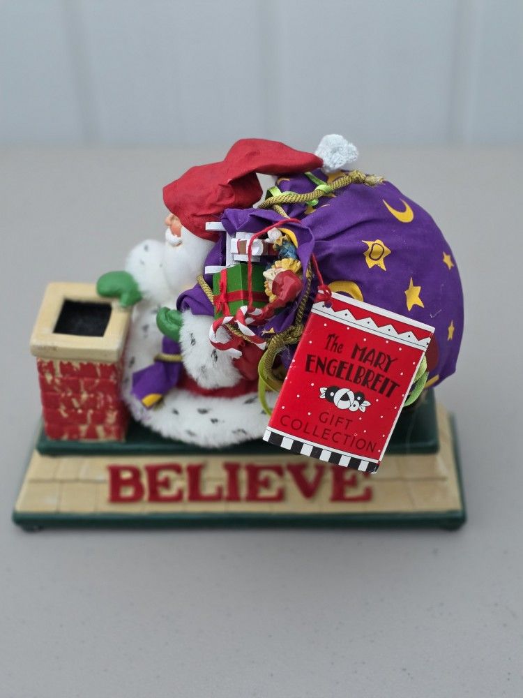 Santa with believe carrying sack on chimney