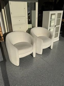 2 white bouclé armchairs